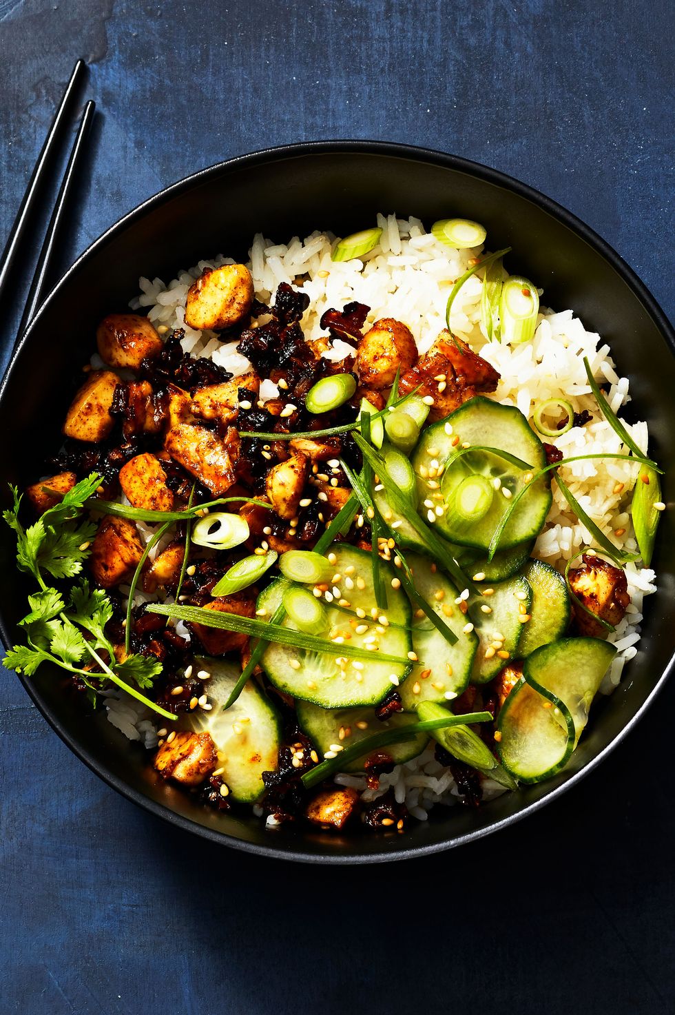 vegan sticky tofu bowl with cucumbers, rice and tofu