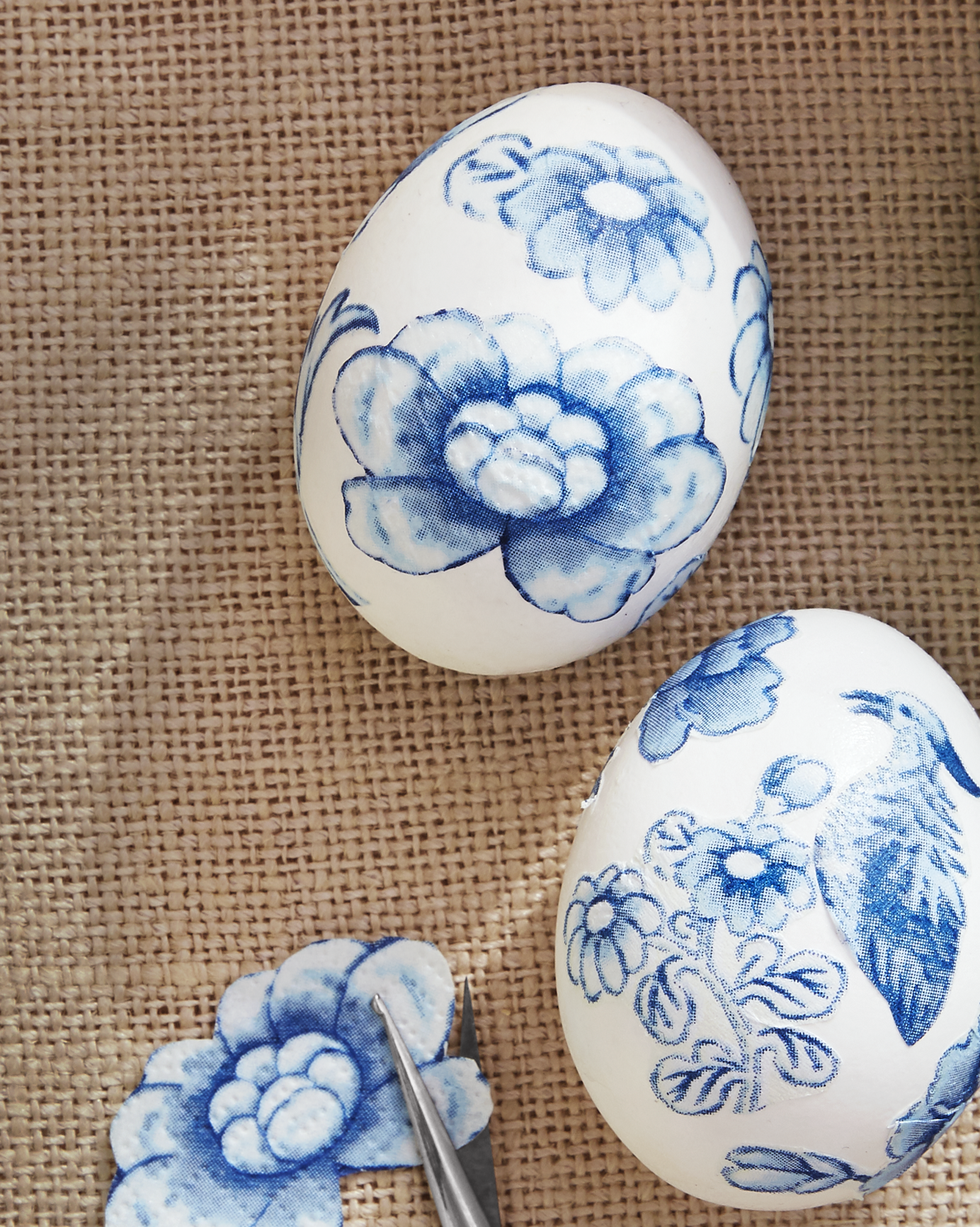easter egg decorating idea featuring cutout and decoupaged pieces from blue and white chinoiserie paper napkins