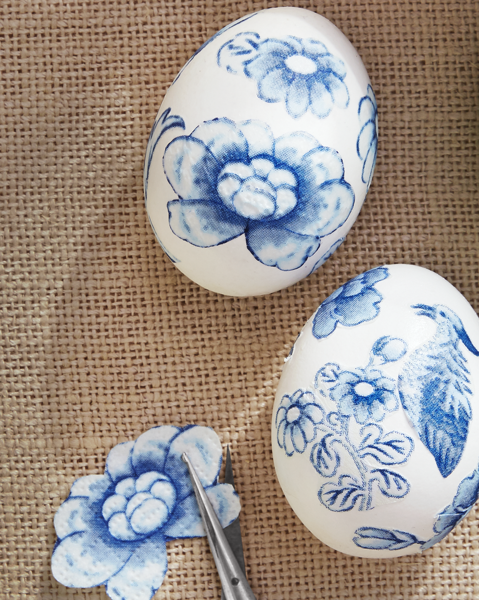 easter egg decorating idea featuring cutout and decoupaged pieces from blue and white chinoiserie paper napkins