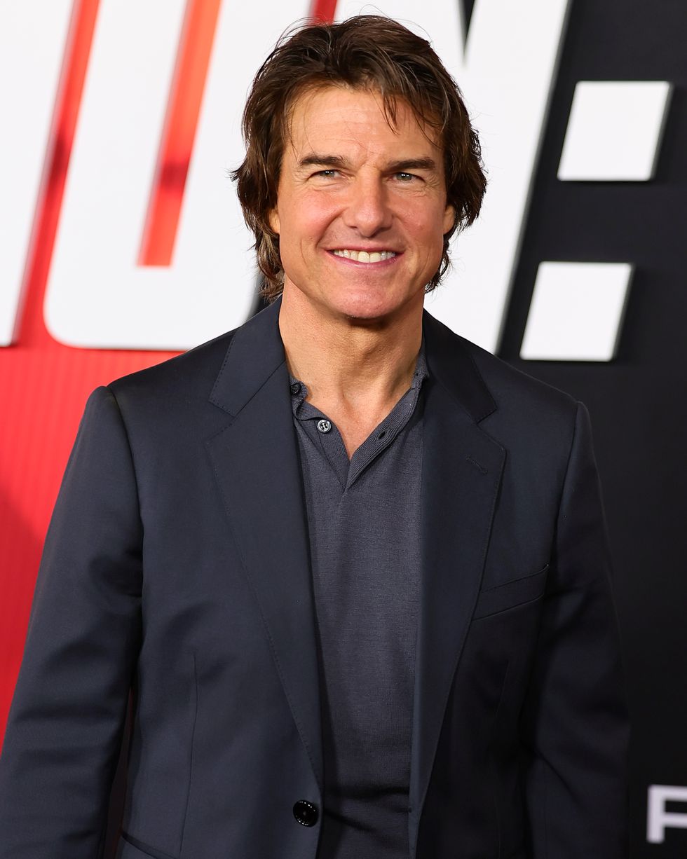 tom cruise smiling on the red carpet of the mission impossible new york premiere