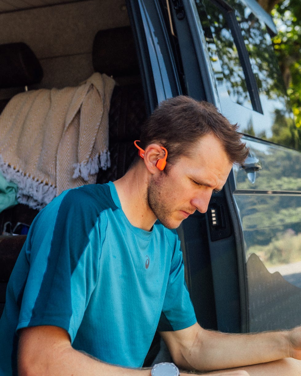 tom evans wearing headphones while sitting out of a van