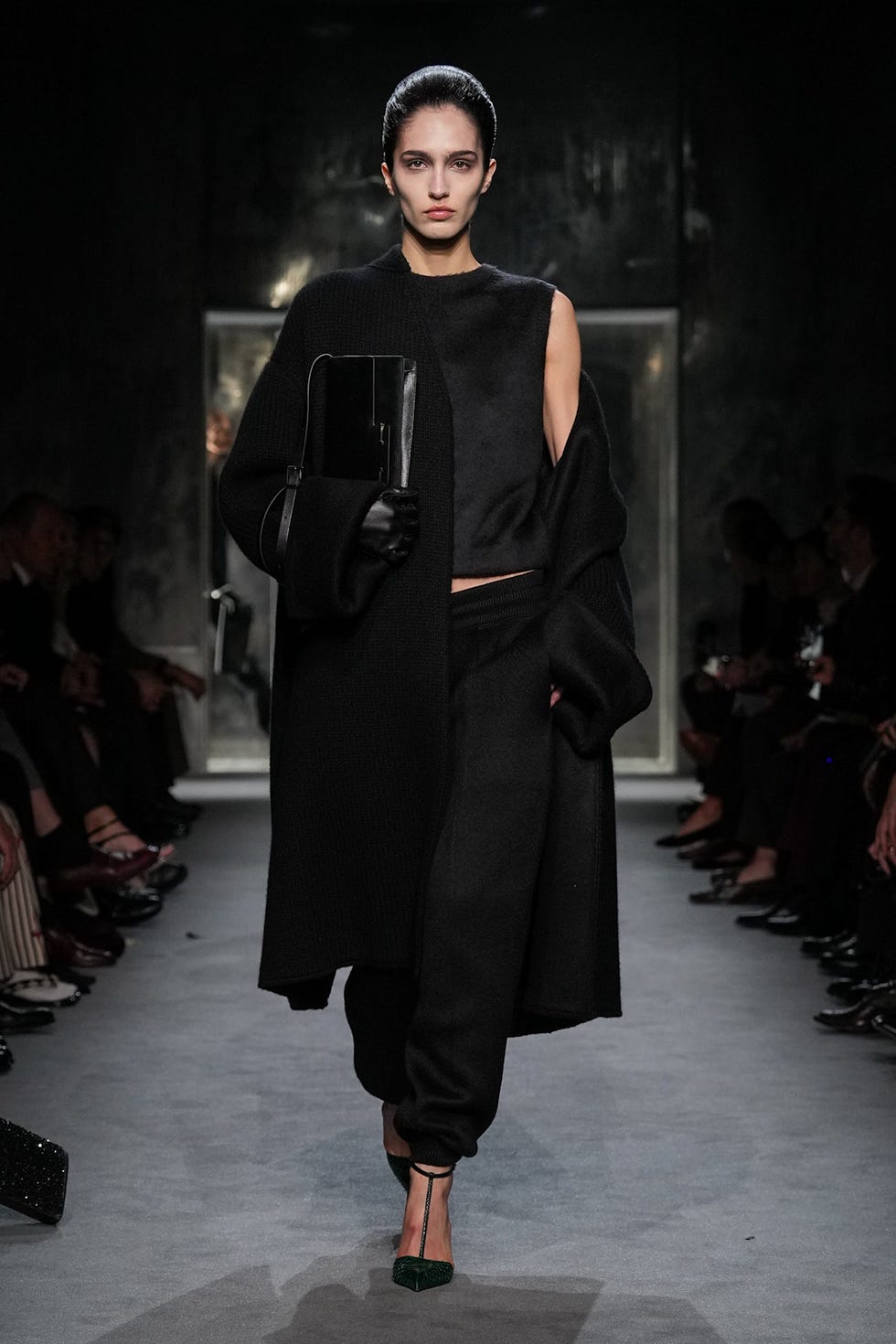 fashion runway model showcasing an allblack ensemble