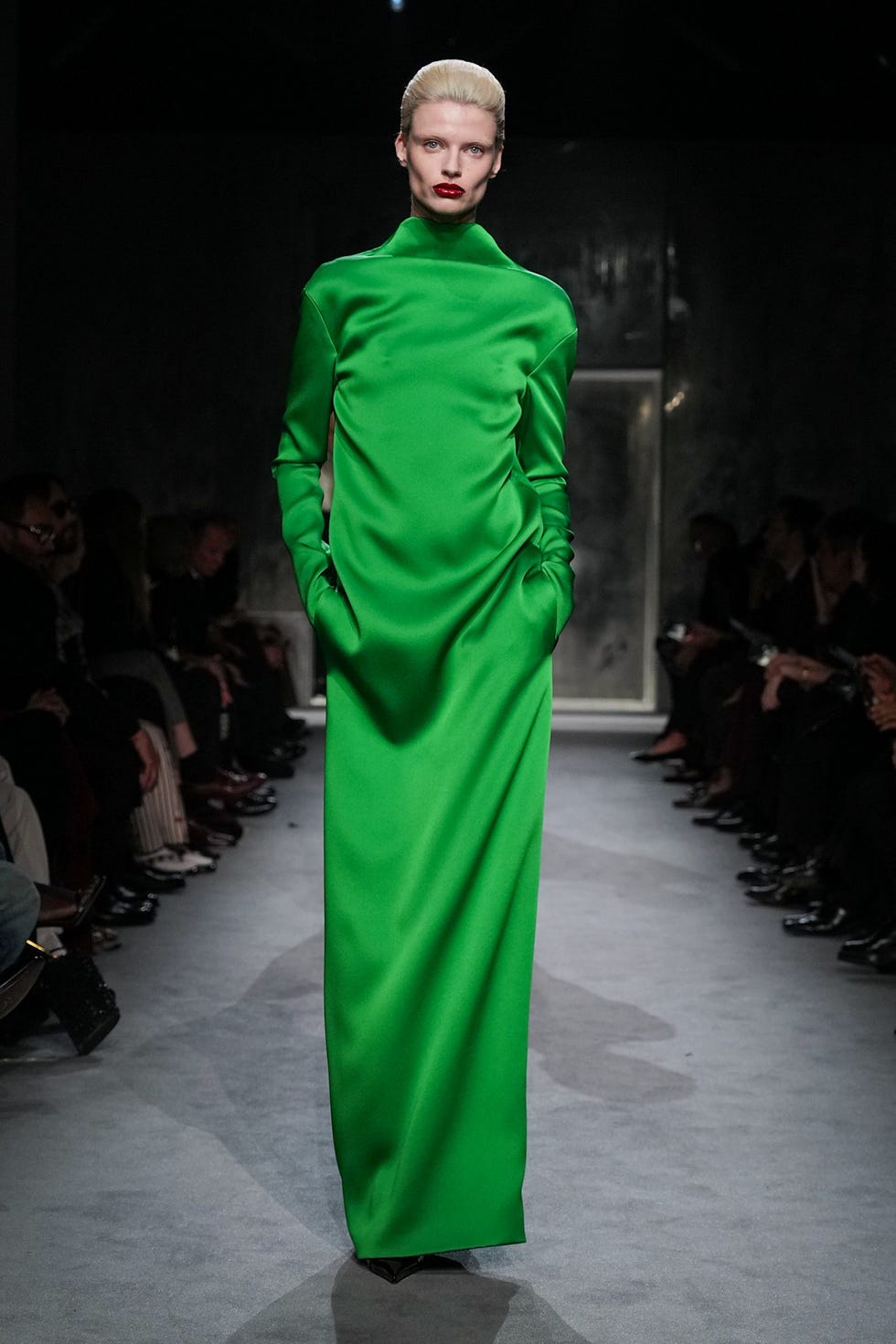 runway model showcasing a long green dress