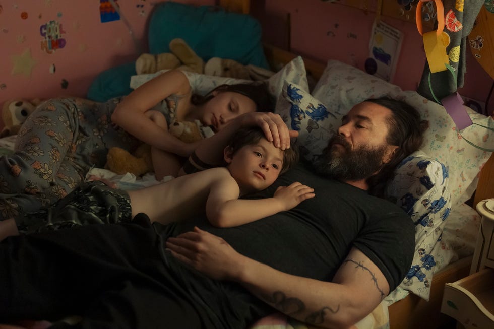 family members relaxing together on a bed