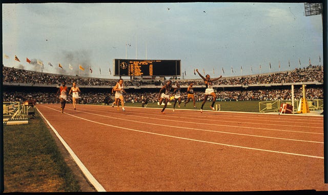 tommie smith crossing the finish line