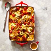 tomato and scallion cream cheese bagel bake in a red baking dish