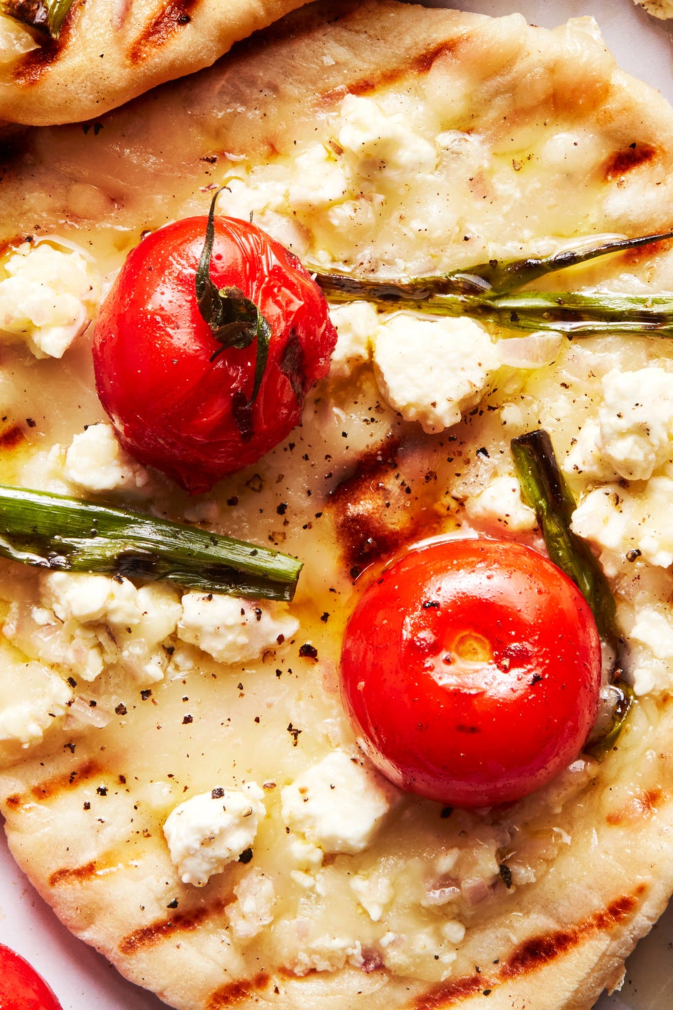 grilled tomato feta pizzettes with scallions and mozzaraella