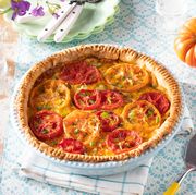 tomato pie with pie server and whole tomatoes