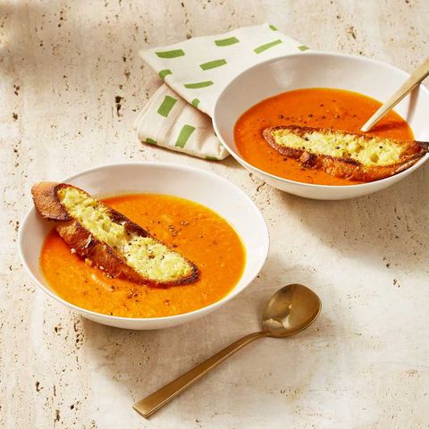 tomato soup with parmesan crostini in a white bowl