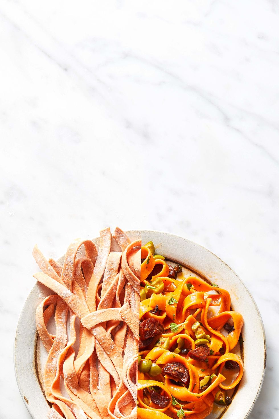 tomato tagliatelle with chorizo and olives on a plate
