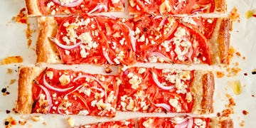 tomato tart topped with red onion and crumbled feta