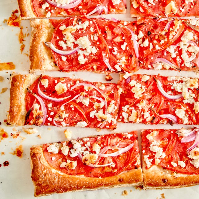 tomato tart topped with red onion and crumbled feta