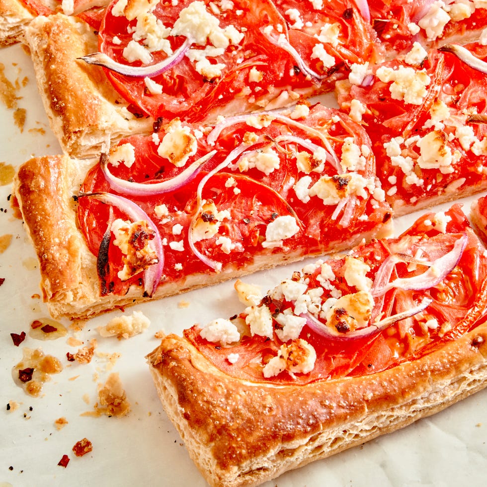 tomato tart topped with red onion and crumbled feta