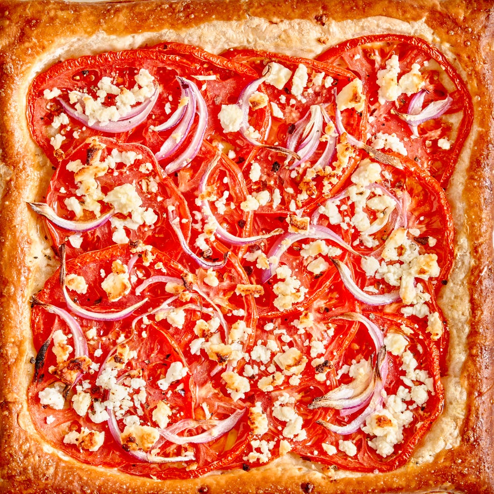 tomato tart topped with red onion and crumbled feta