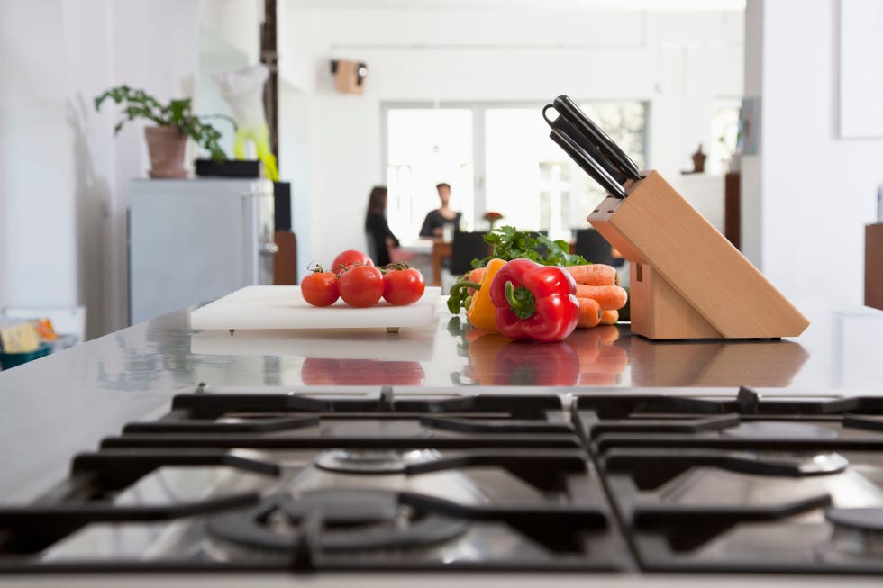 tomatoes, carrots and bell peppers on a kitchen counter