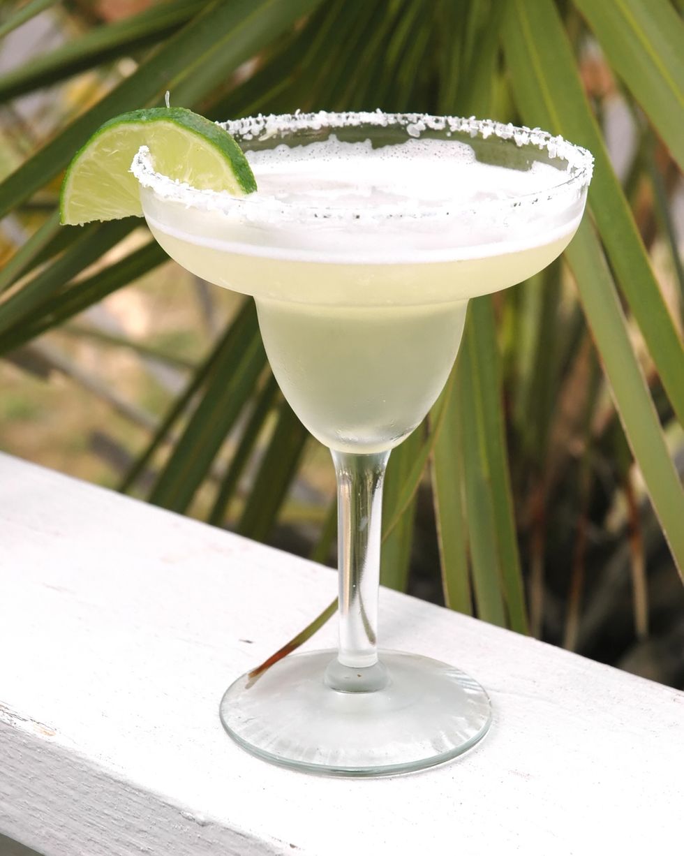 margarita with salt and lime with palm tree in background