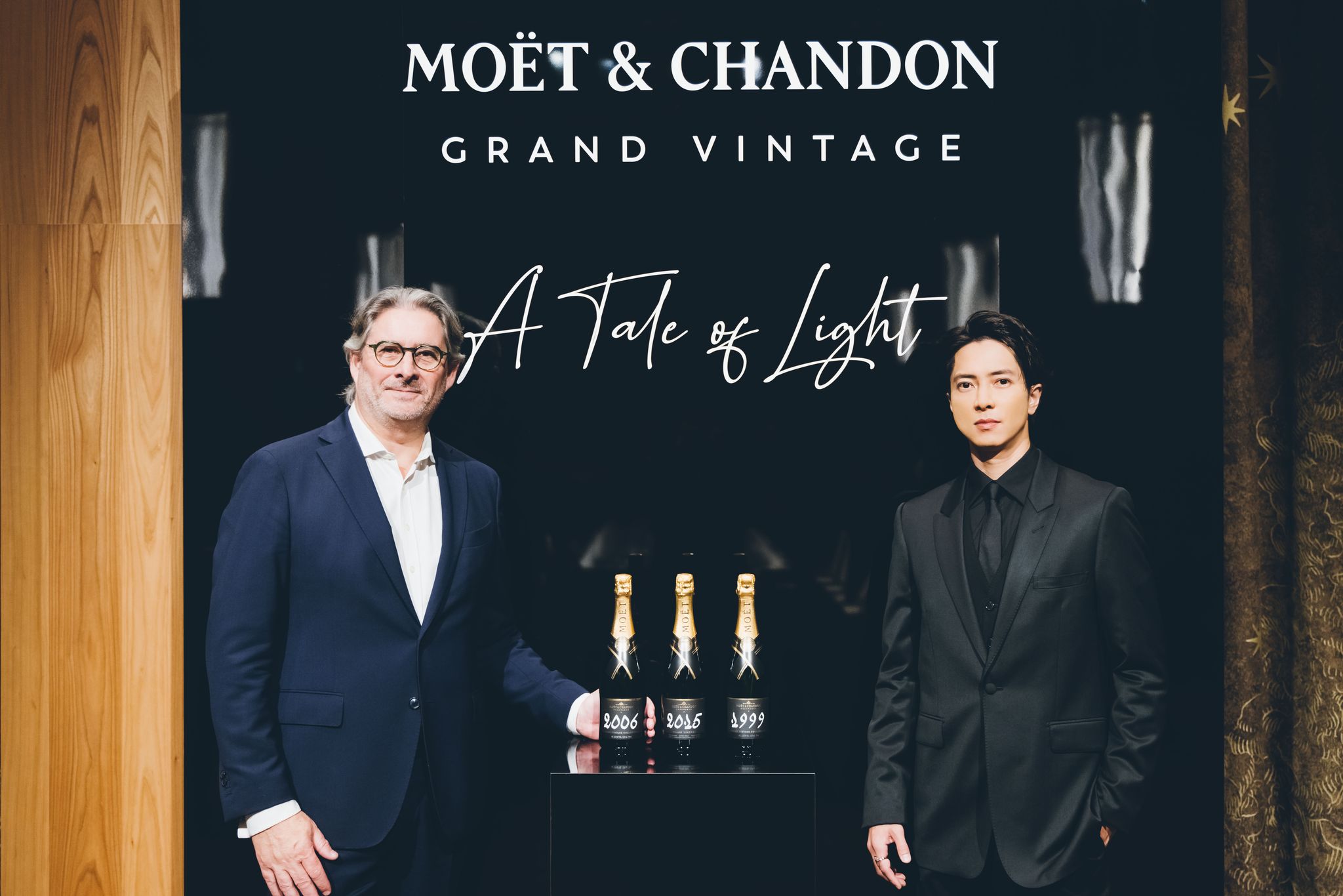 benoit goez and tomohisa yamashita standing in front of the bottles of moet et chandon grand vintage "a tales of light"