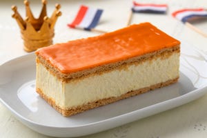 traditional dutch orange tompouce pastry for kings day with crown and flag on the background