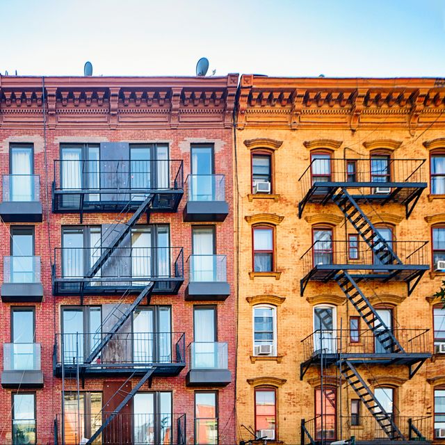 top stories of colorful williamsburg apartment buildings with steel fire escape stairways