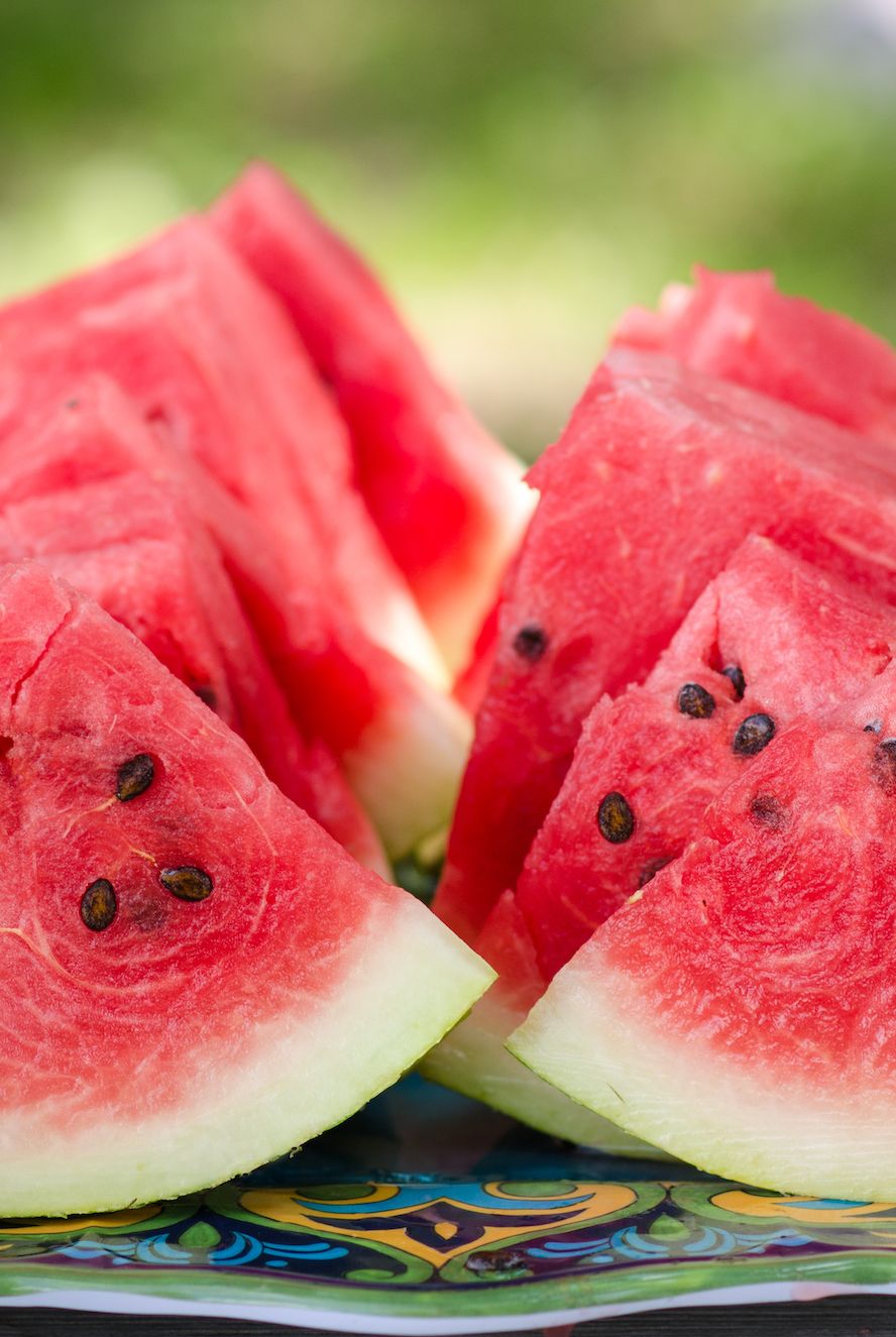 summer foods slices of watermelon on blue picnic table