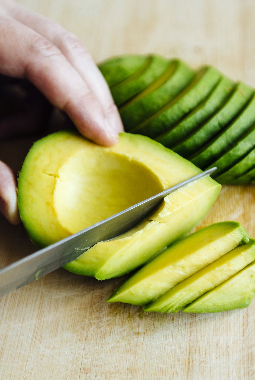 summer foods person slicing an avocado