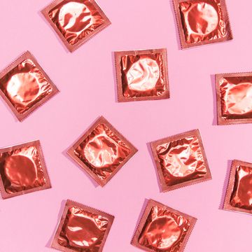 top view condoms red wrappers,directly above shot of pink desserts on pink background