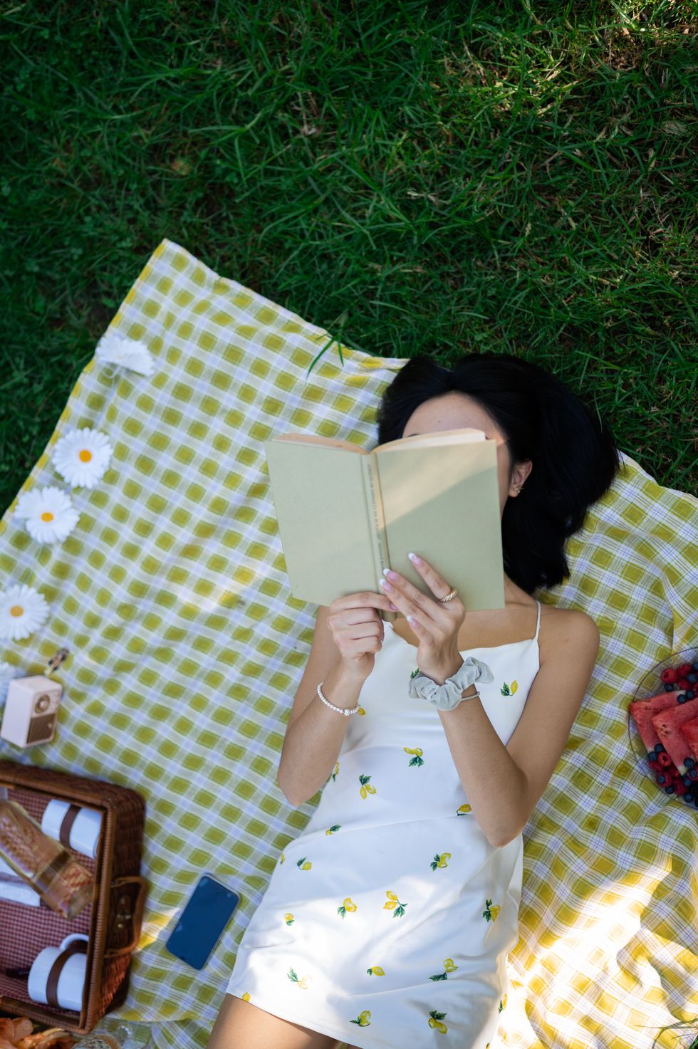 top view of a woman reading a book in the park