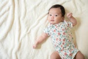 top view of cute little asian baby girl cheerful and looking at the camera with copy space