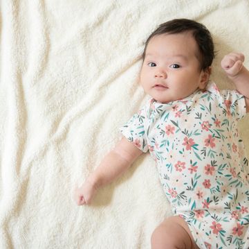 top view of cute little asian baby girl cheerful and looking at the camera with copy space