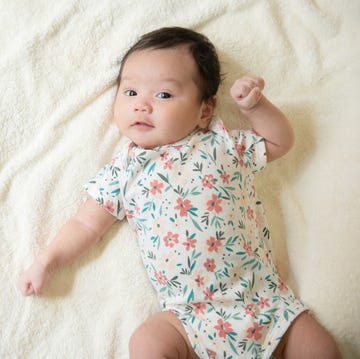 top view of cute little asian baby girl cheerful and looking at the camera with copy space