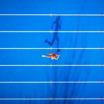 Top view of female runner on tartan track top view of female runner on tartan track