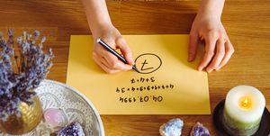 top view of girl calculate life path number on paper in home table spiritual numerology concept