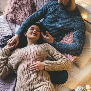 top view of passionate romantic couple spending time before new year at home with garlands