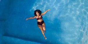 woman floating in swimming pool