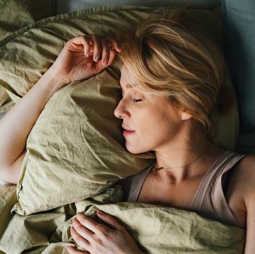 top view of woman sleeping in bed