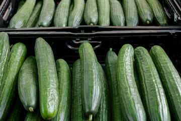 top view, various type of cucumbers on plastic basket of stall