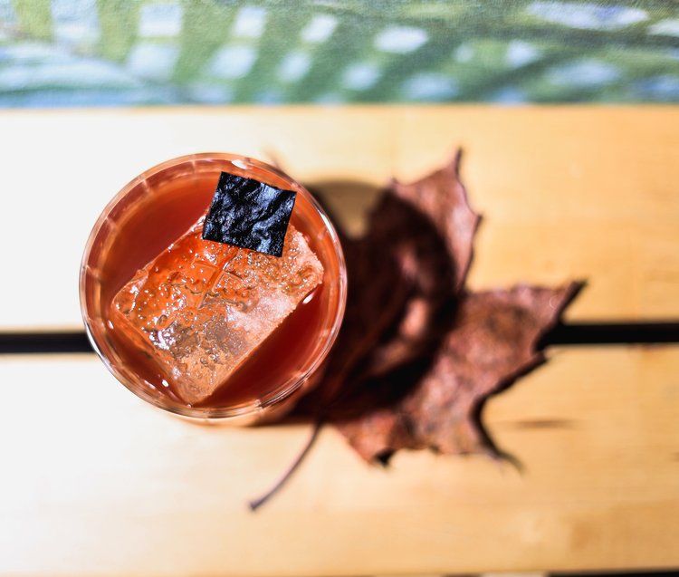 a cocktail on top of a maple leaf