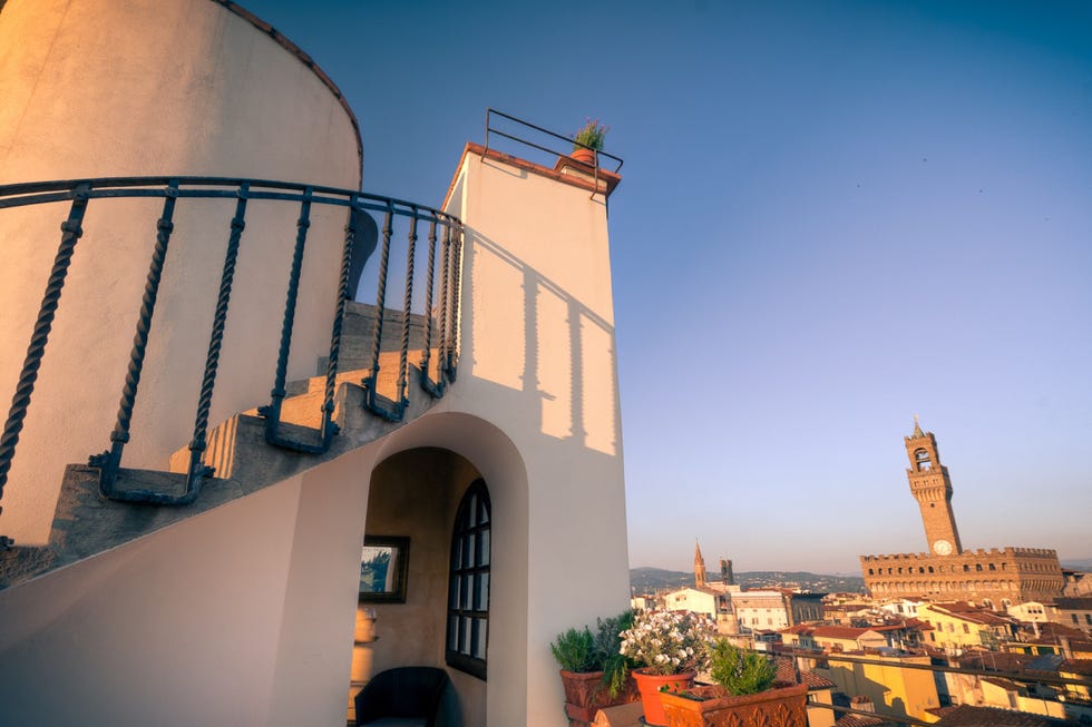 hotel torre guelfa tower at golden hour, facing the palazzo vecchio in florence and overlooking other key city buildings