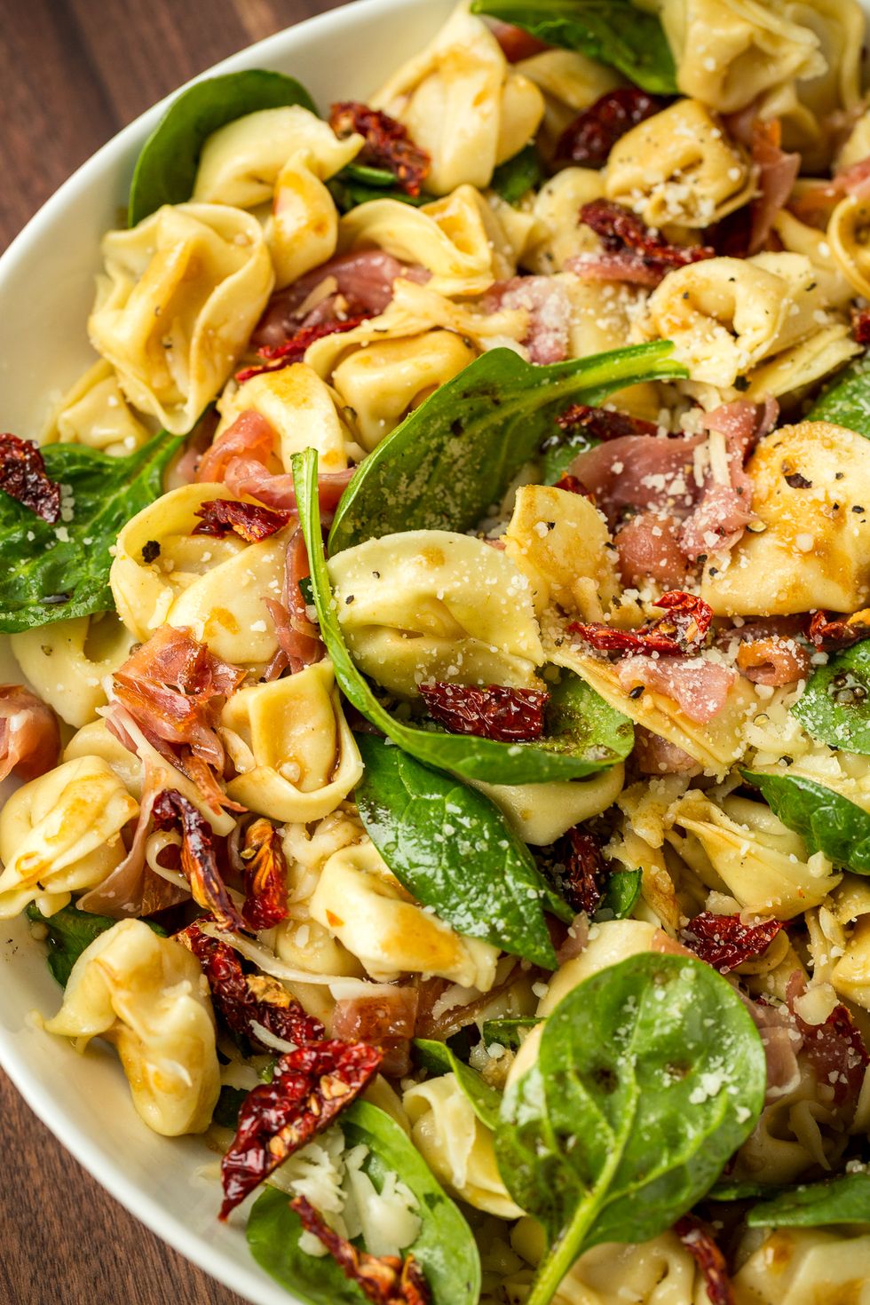 tortellini salad with spinach, sundried tomatoes, prosciutto, and parmesan