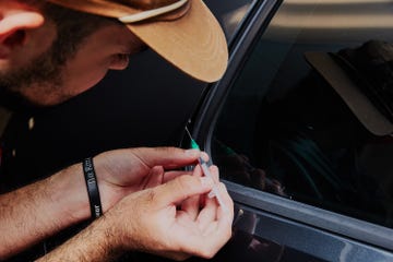 matt using a syringe to touch up paint on a vechile