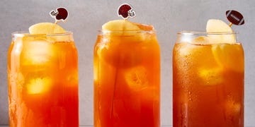 tea in a glass with a peach slice and mini football garnish