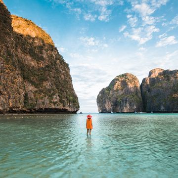 tourist admiring the view at maya bay, phi phi islands, thailand