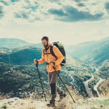 tourist man enjoying nordic walking in the mountain