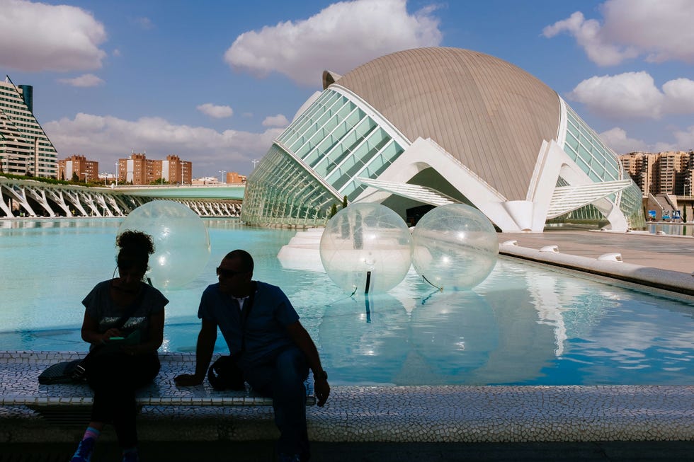 Tourists around the Hemisferic building. The Hemisfèric was...