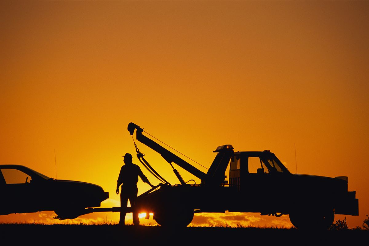 tow truck operator at sunset