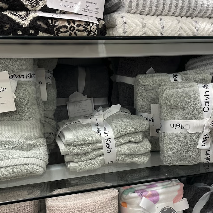 display of various towels including bath towels and washcloths from branded labels