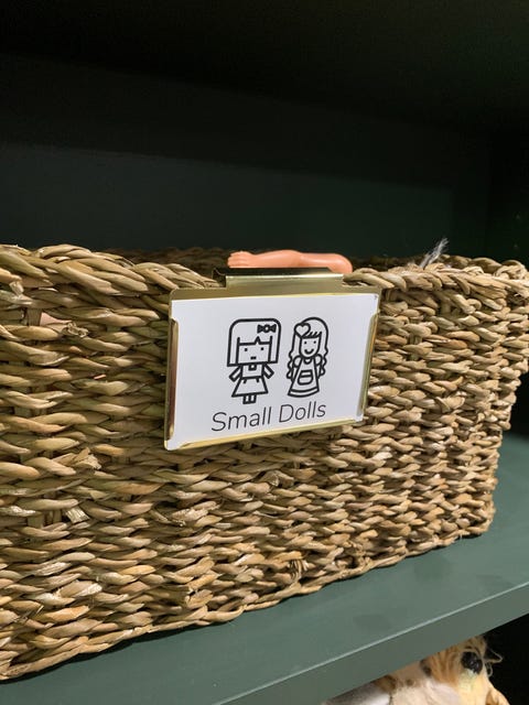 toy organization tips toy bin with label reading small dolls and a photo of dolls