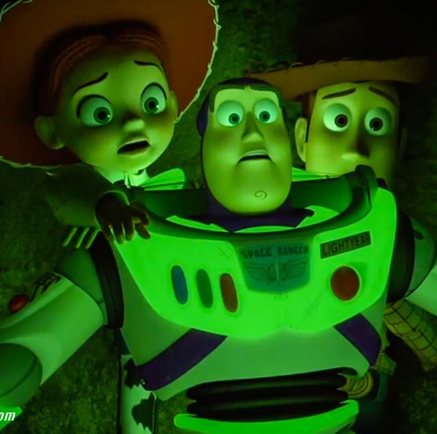 jessie, buzz and woody are bathed in an eerie green light in a scene from 'toy story of terror,' a good housekeeping pick for best halloween movies for kids