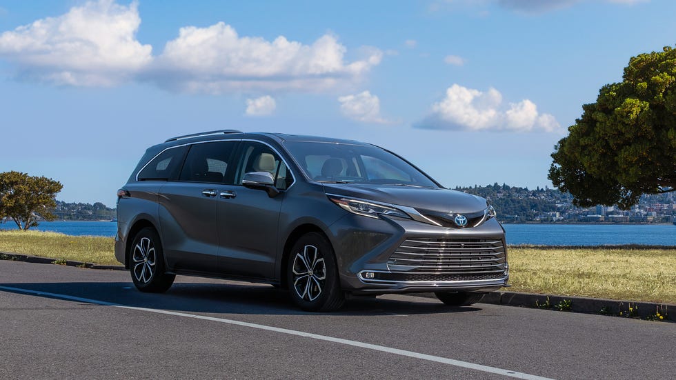 Rear view of the 2025 Toyota Sienna with its power tailgate open, revealing the spacious cargo area and third-row seats folded flat.