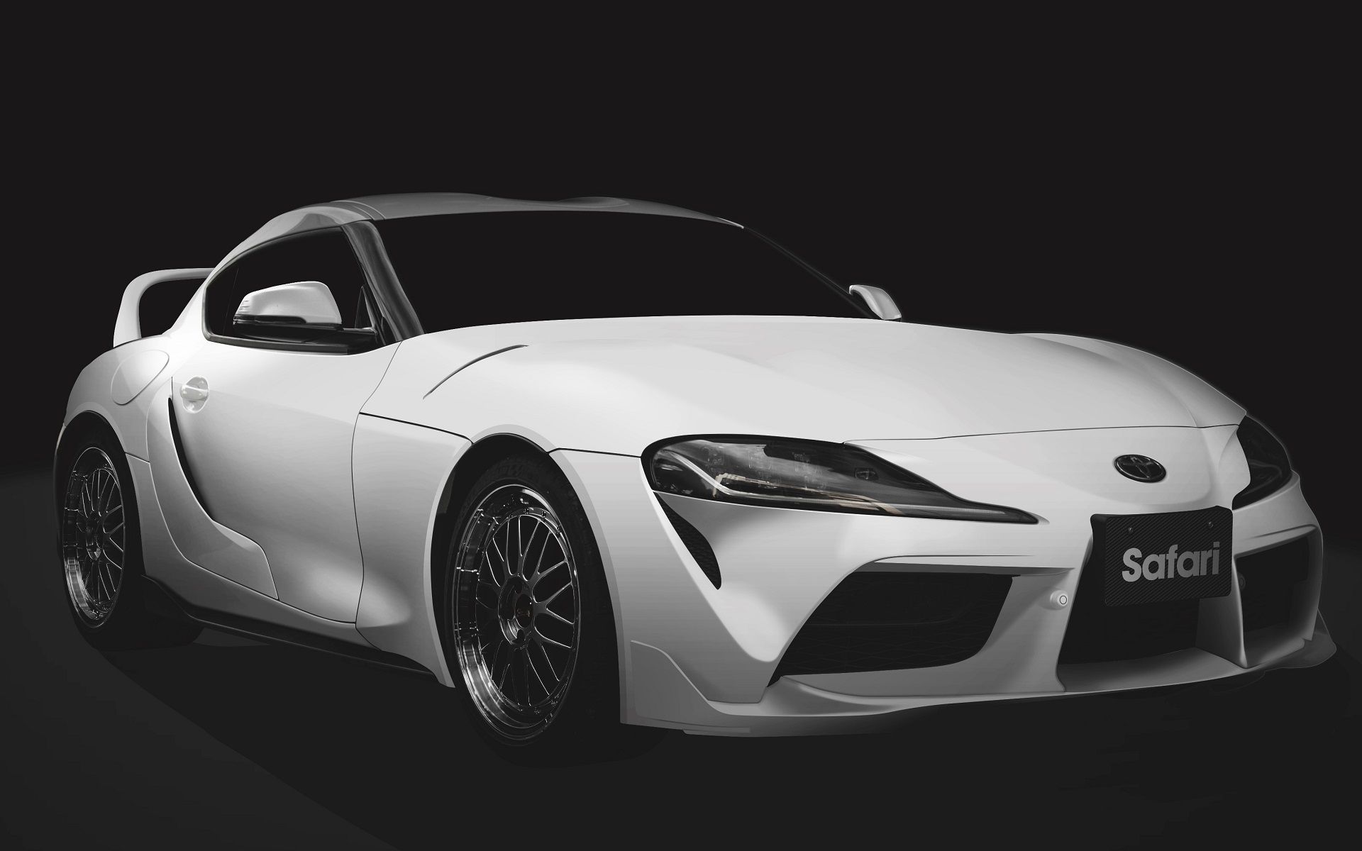 Un coche de carreras toyota supra con pintura blanca y negra